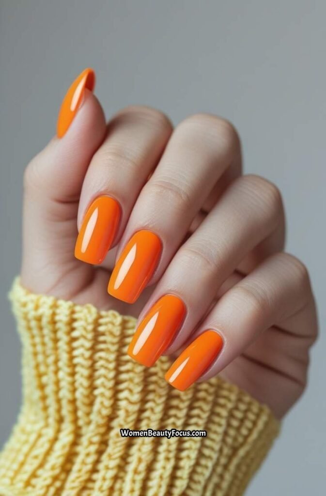 1. Bold Tangerine Nails with Glossy Finish