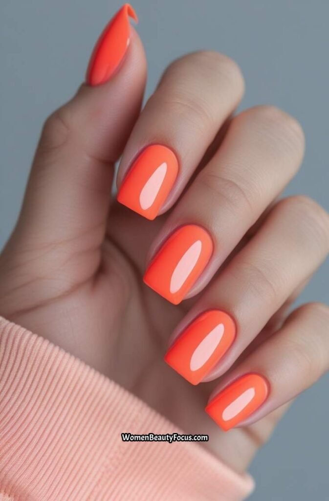 1. Bright Coral Square Nails with Glossy Finish
