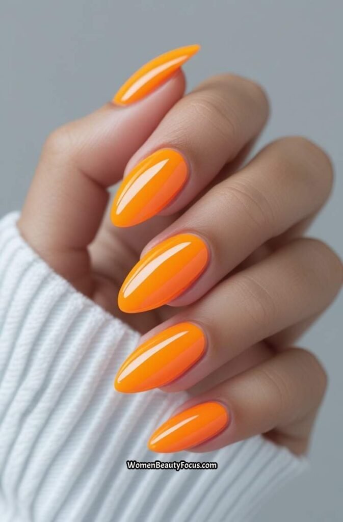 1. Citrus Orange Almond Nails with Glossy Finish