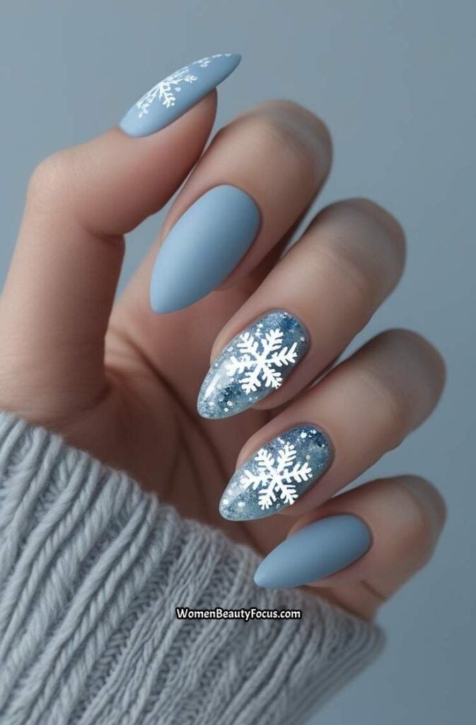 1. Frosted Blue Almond Nails with Snowflake Accents