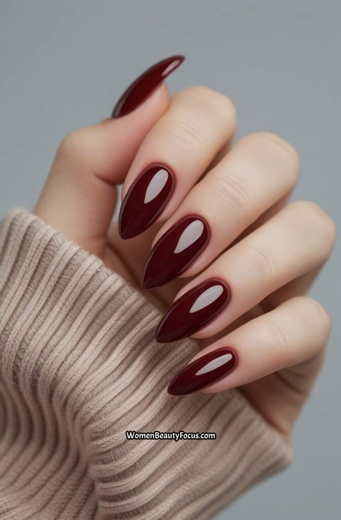 1. Glossy Cherry Brown Almond Nails
