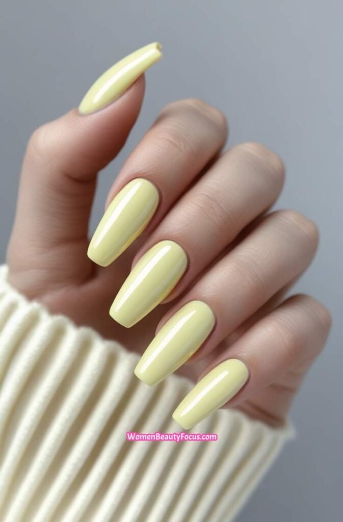 1. Glossy Pastel Yellow Coffin Nails