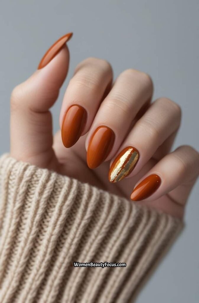 1. Rust Orange Nails with Gold Accents