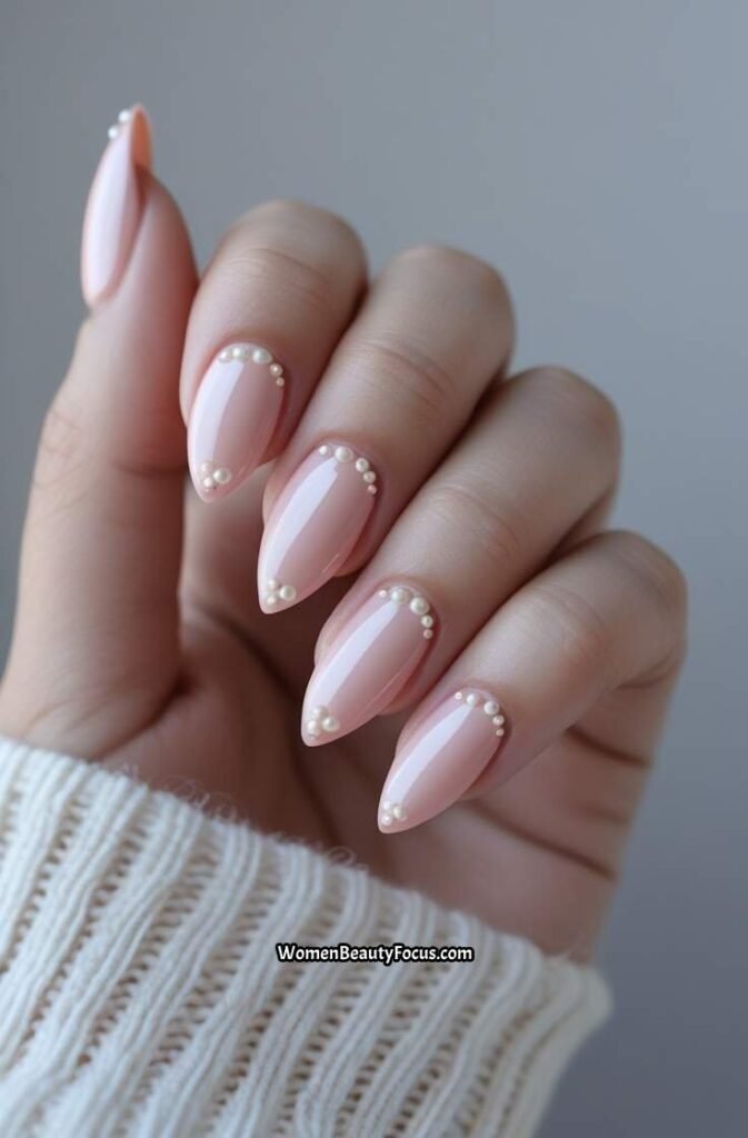 11. Blush Almond Nails with Pearl Accents