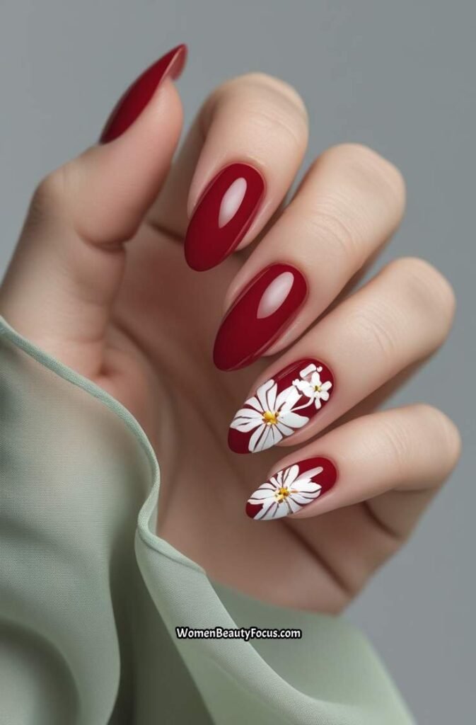 11. Glossy Red Oval Nails with White Floral Accents