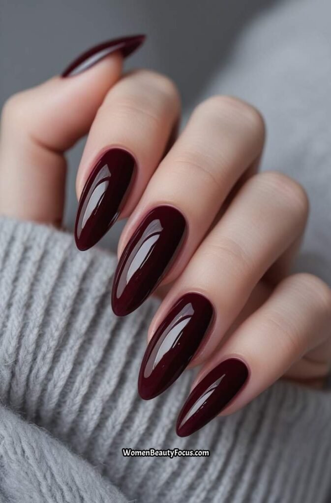 2. Glossy Burgundy Oval Nails