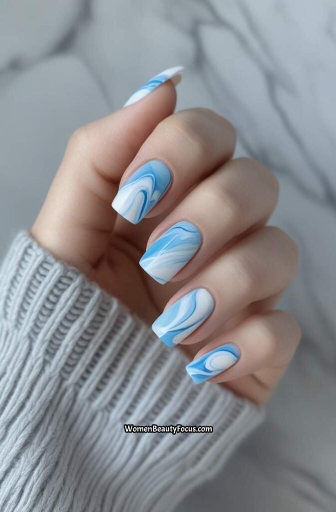 2. Soft Blue and White Marble Nails