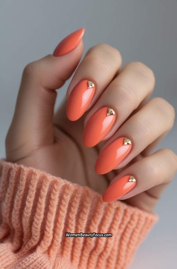 3. Glossy Coral Nails with Gold Accents