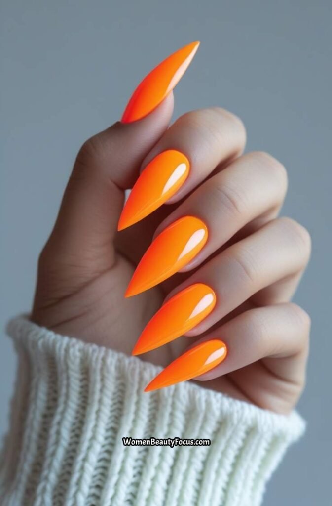 3. Neon Orange Stiletto Nails