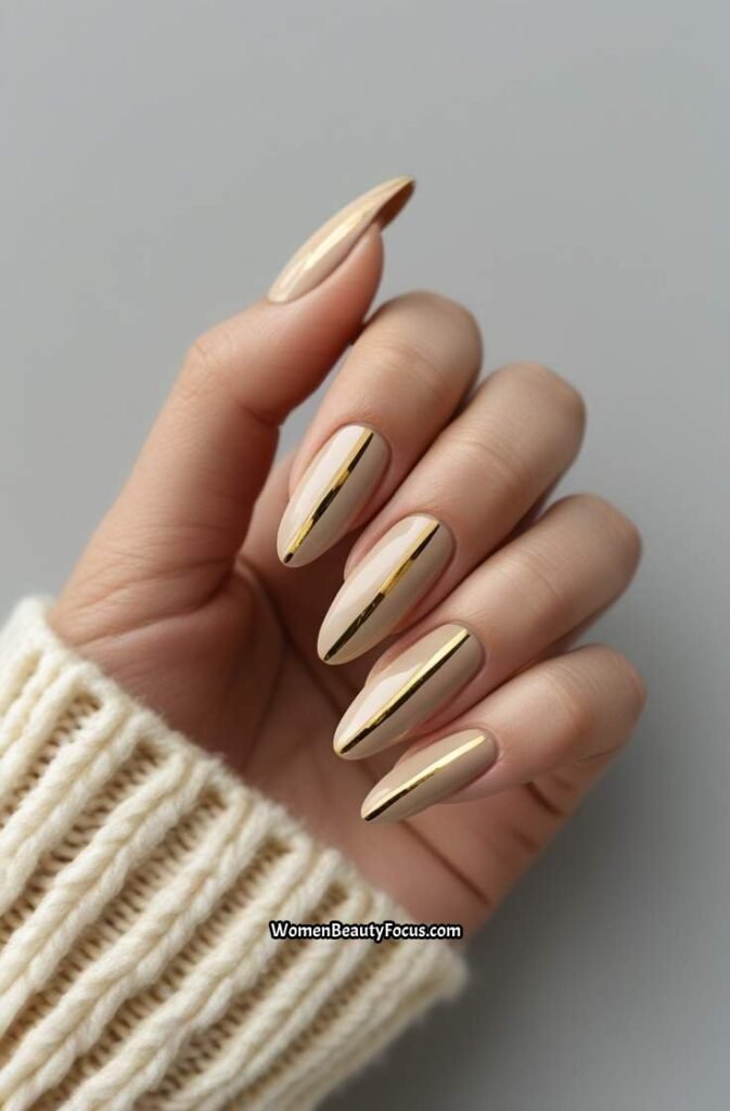 3. Neutral Almond Nails with Gold Stripes