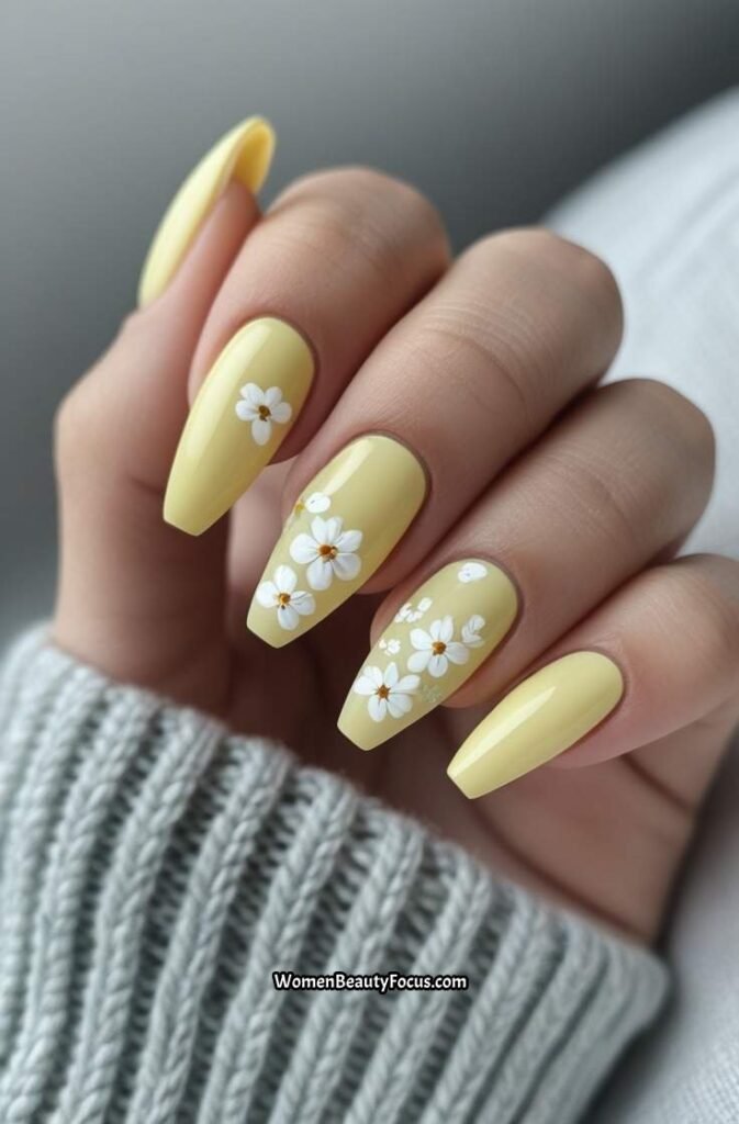 3. Pastel Yellow Coffin Nails with Floral Accents