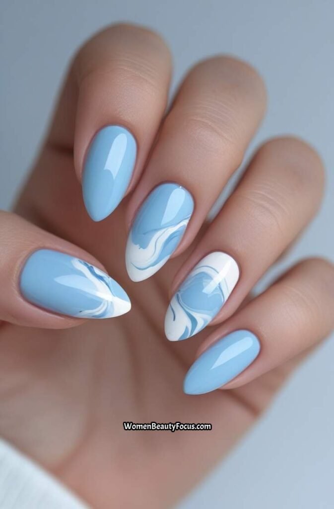 4. Baby Blue Almond Nails with White Marble Accents