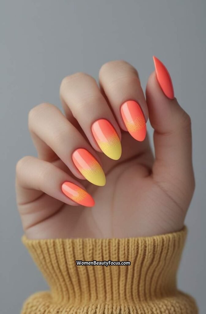 4. Coral Aura Nails with Yellow Center