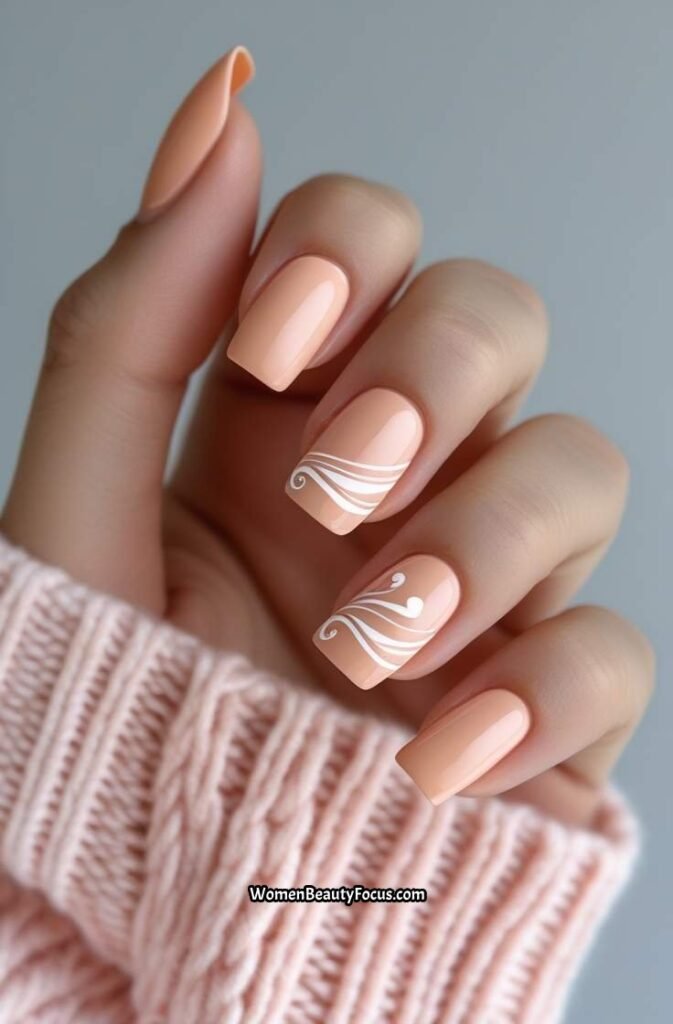 5. Soft Peach Nails with White Swirls