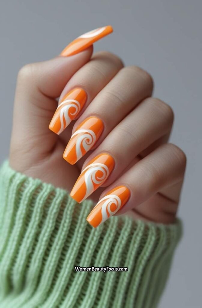 6. Orange and White Swirl Nails
