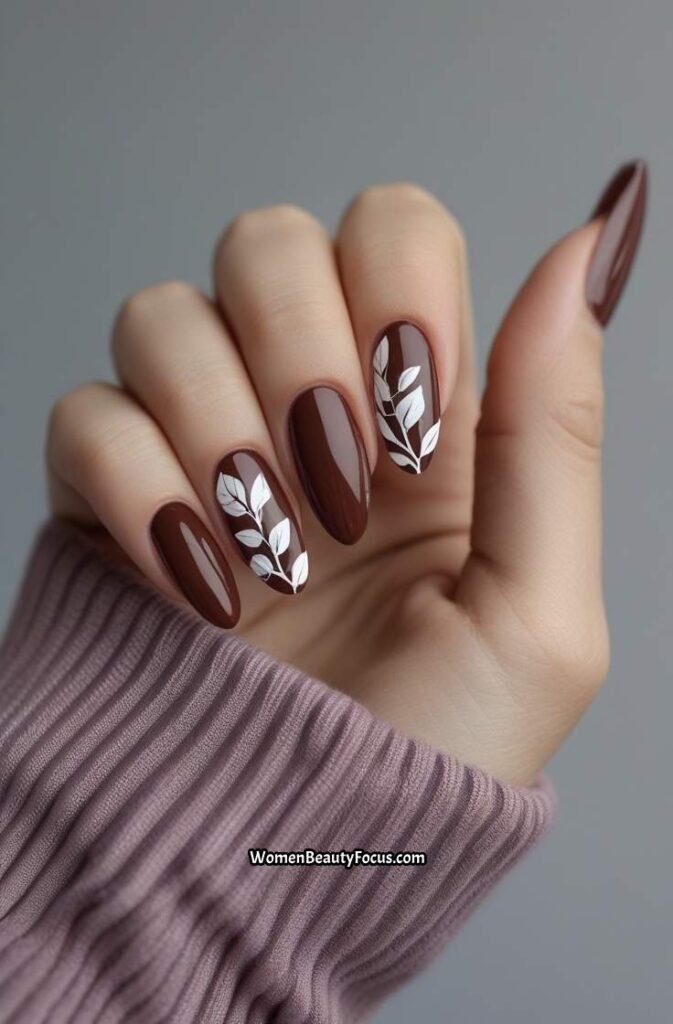 7. Cherry Brown Nails with Leaf Art Accents