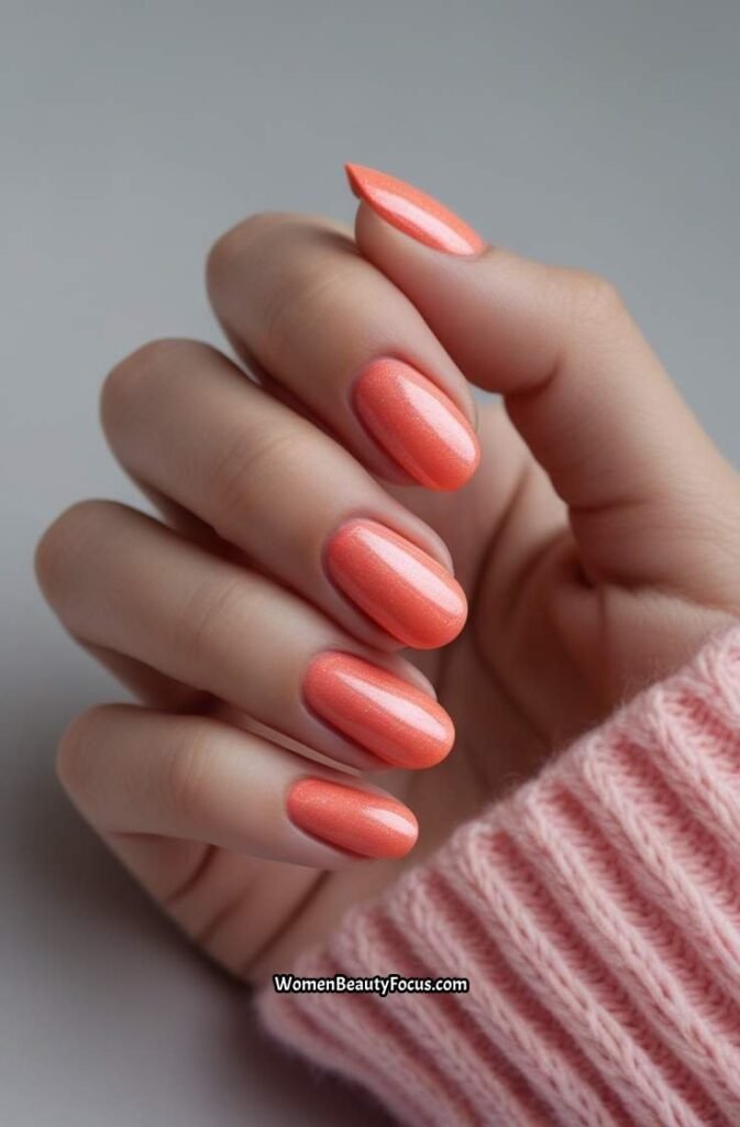 7. Coral Nails with Subtle Shimmer
