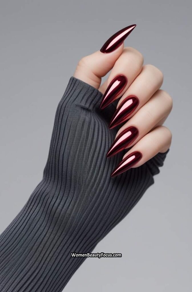 7. Deep Red Stiletto Nails with Chrome Finish