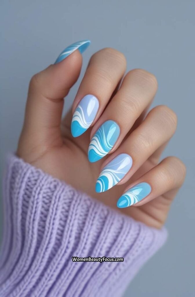 7. Pastel Blue and White Swirl Nails