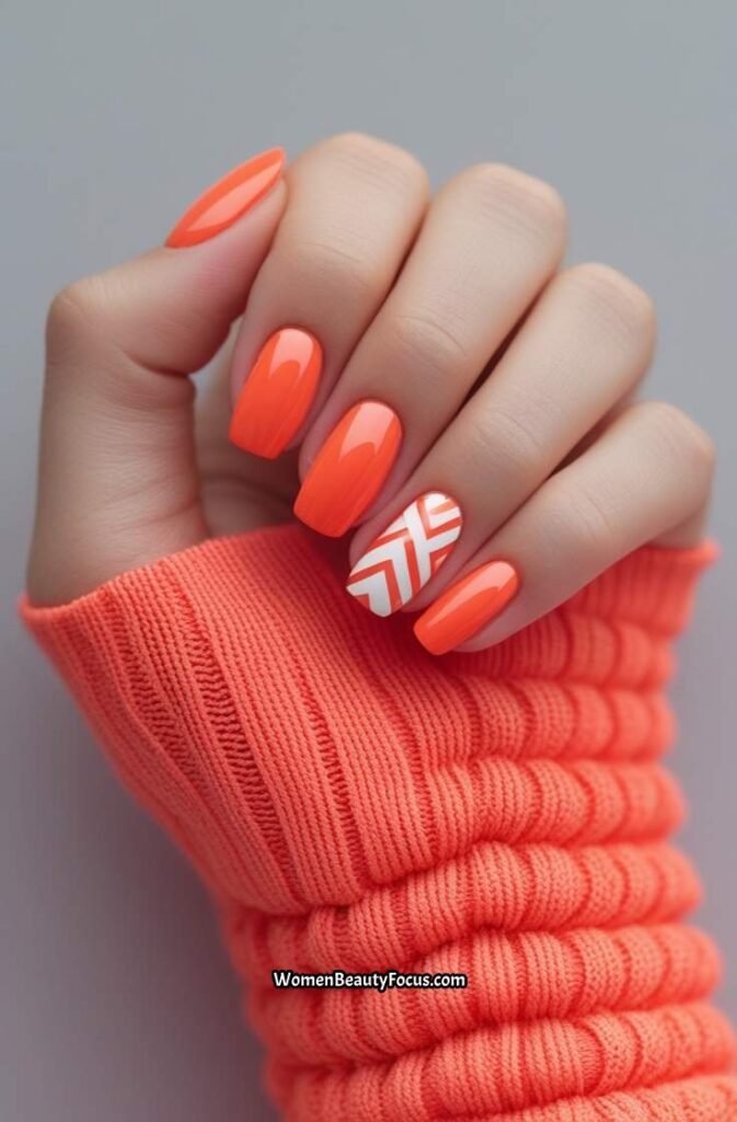 8. Coral Orange Nails with White Geometric Shapes