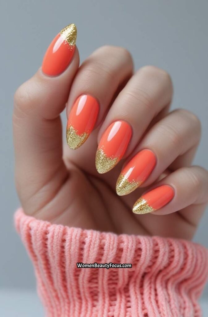 9. Coral Almond Nails with Gold Glitter Tips