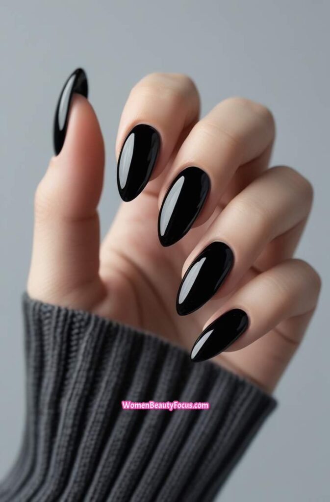 1. Glossy Black Almond Nails with Mirror Shine