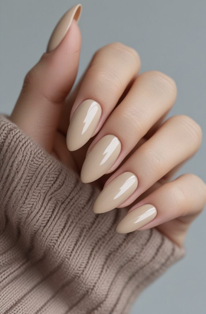 1. Soft Beige Almond Nails with Glossy Finish