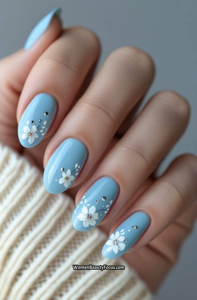 10. Baby Blue Nails with Floral Accents