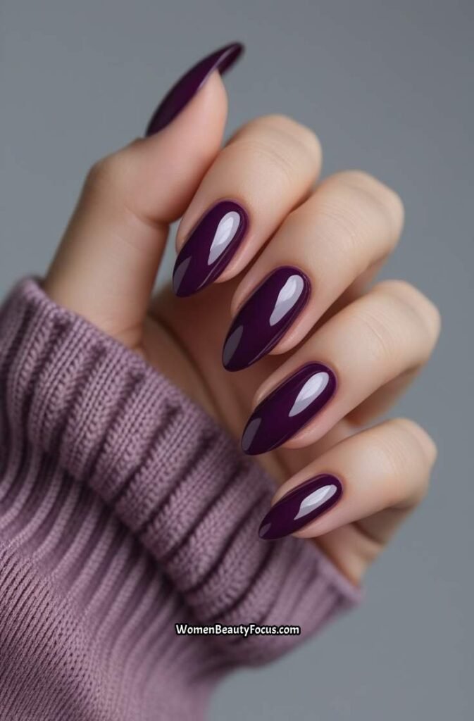 10. Deep Plum Nails with Glossy Finish