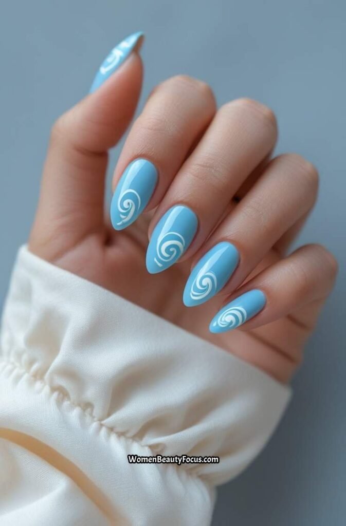 10. Sky Blue Almond Nails with White Swirls