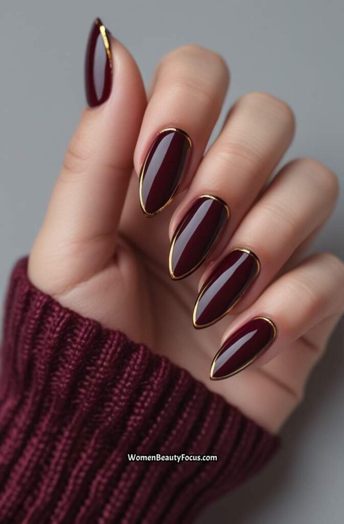 11. Deep Burgundy Nails with Gold Detailing
