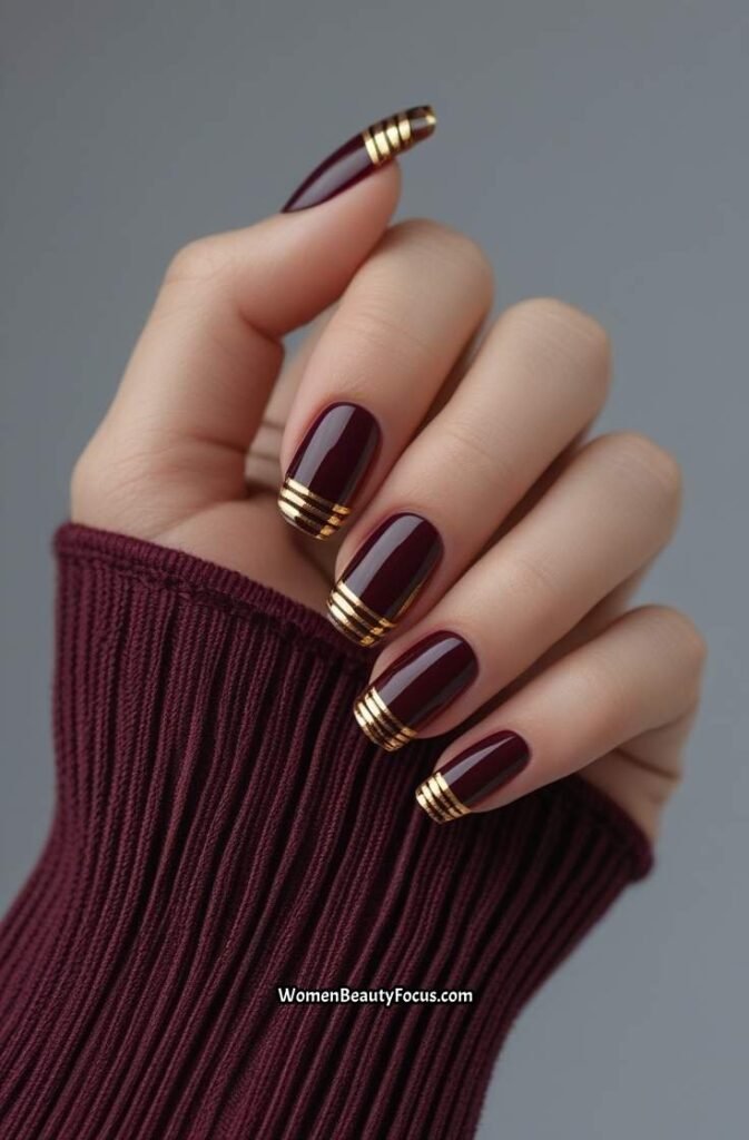 11. Deep Burgundy and Gold Accent Nails