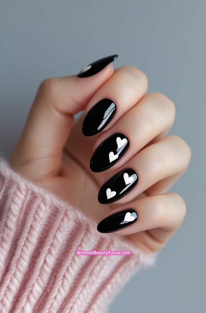 11. Glossy Black Nails with Heart Accents