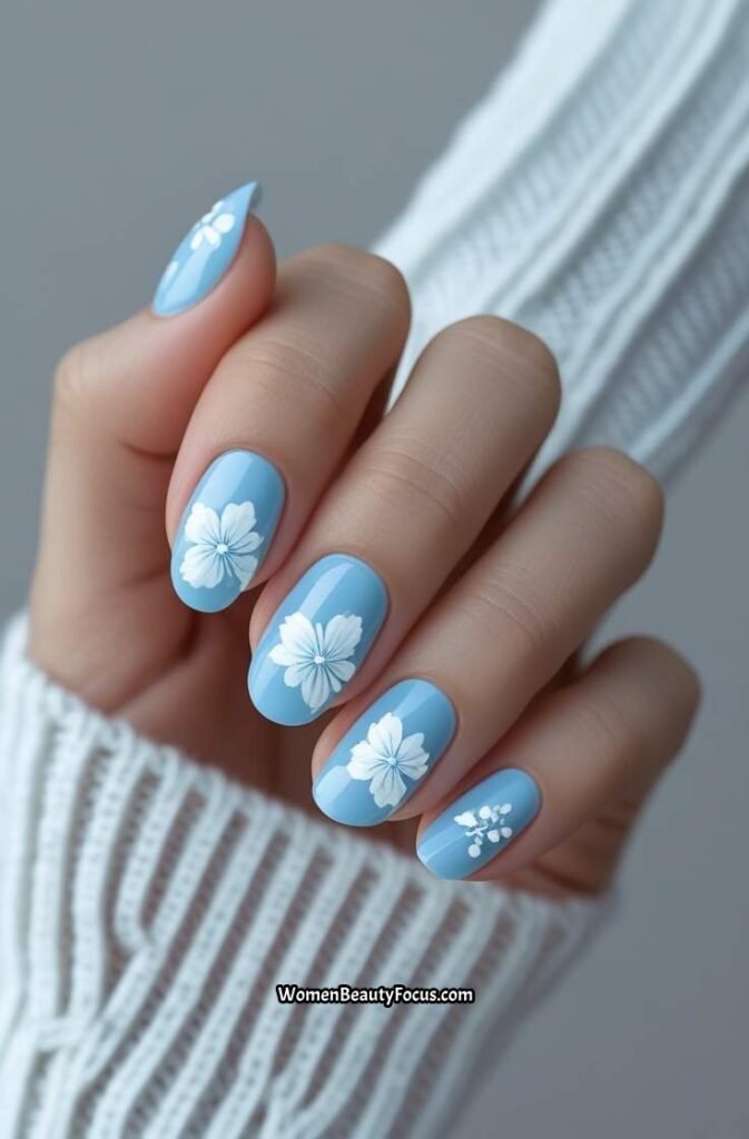 11. Light Blue Nails with White Floral Details