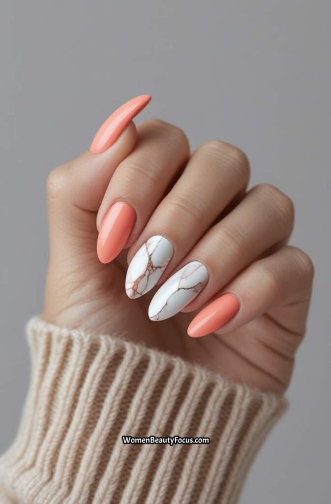 11. Soft Coral Almond Nails with White Marble