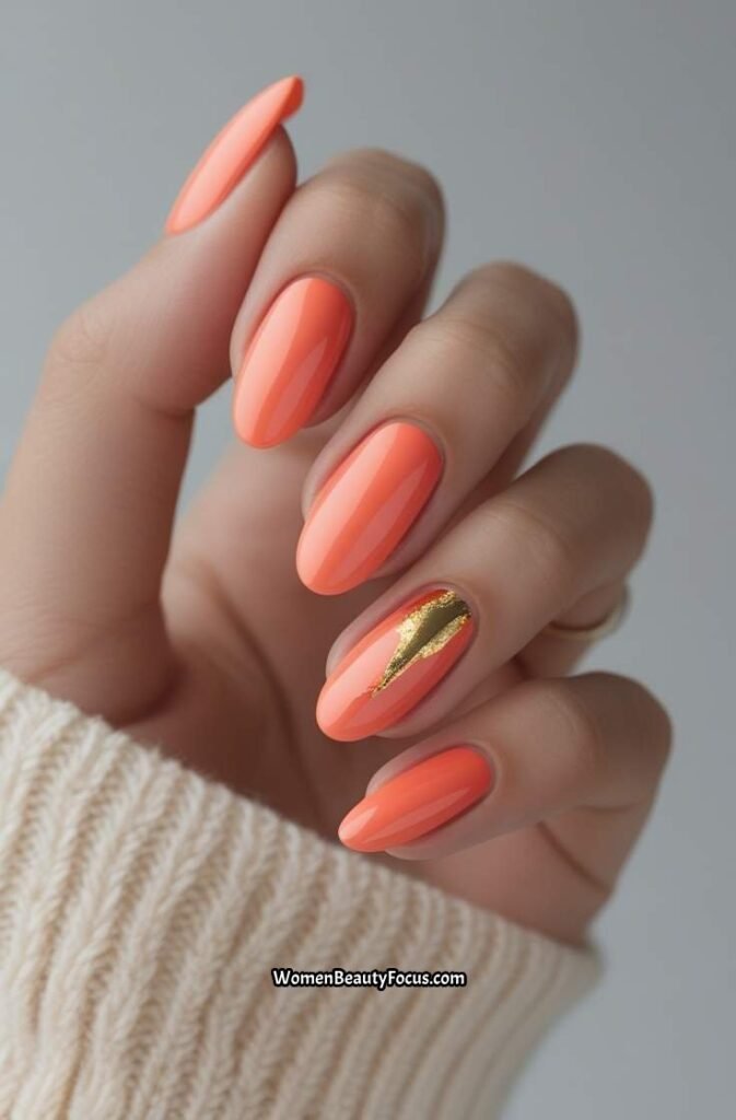 11. Soft Coral Oval Nails with Subtle Gold Foil