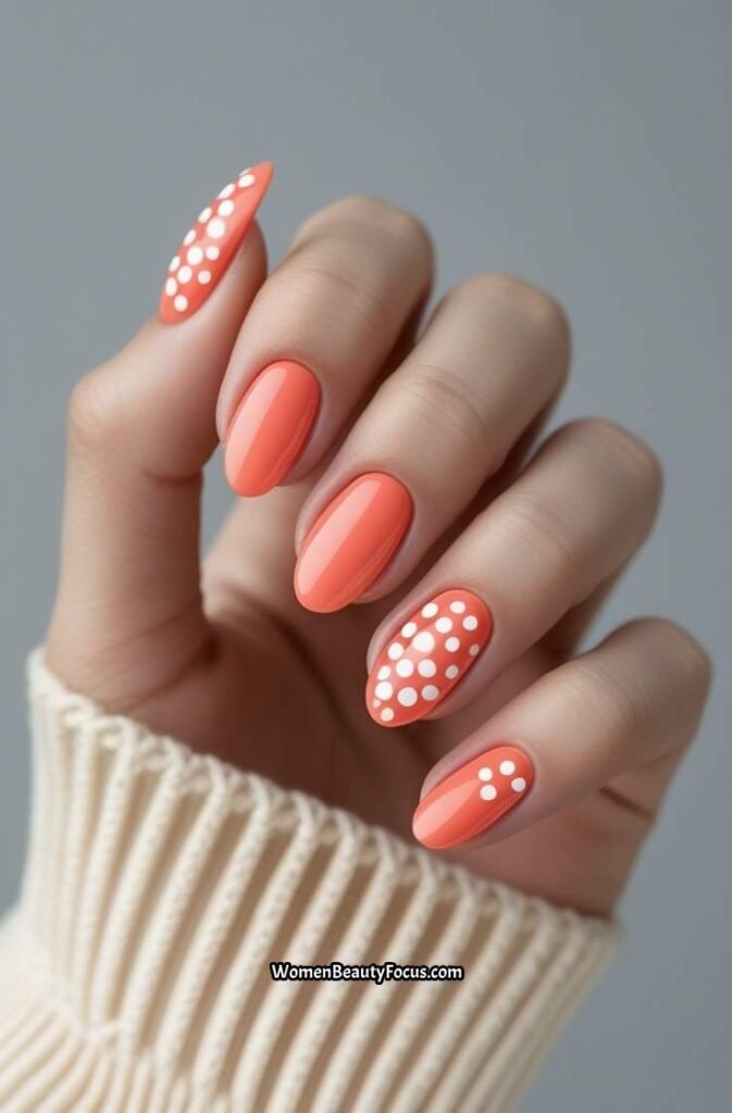 11. Soft Coral Oval Nails with White Polka Dots