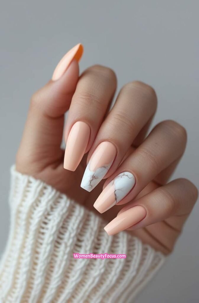 11. Soft Peach Nails with White Marble Accents