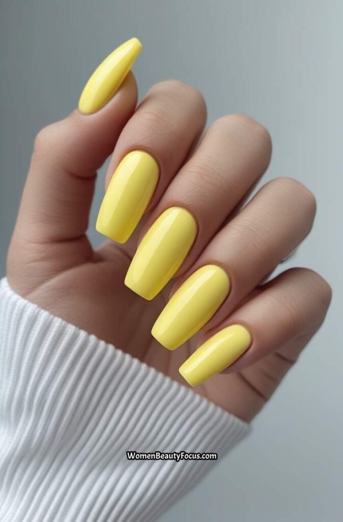 12. Lemon Yellow Coffin Nails with Glossy Shine