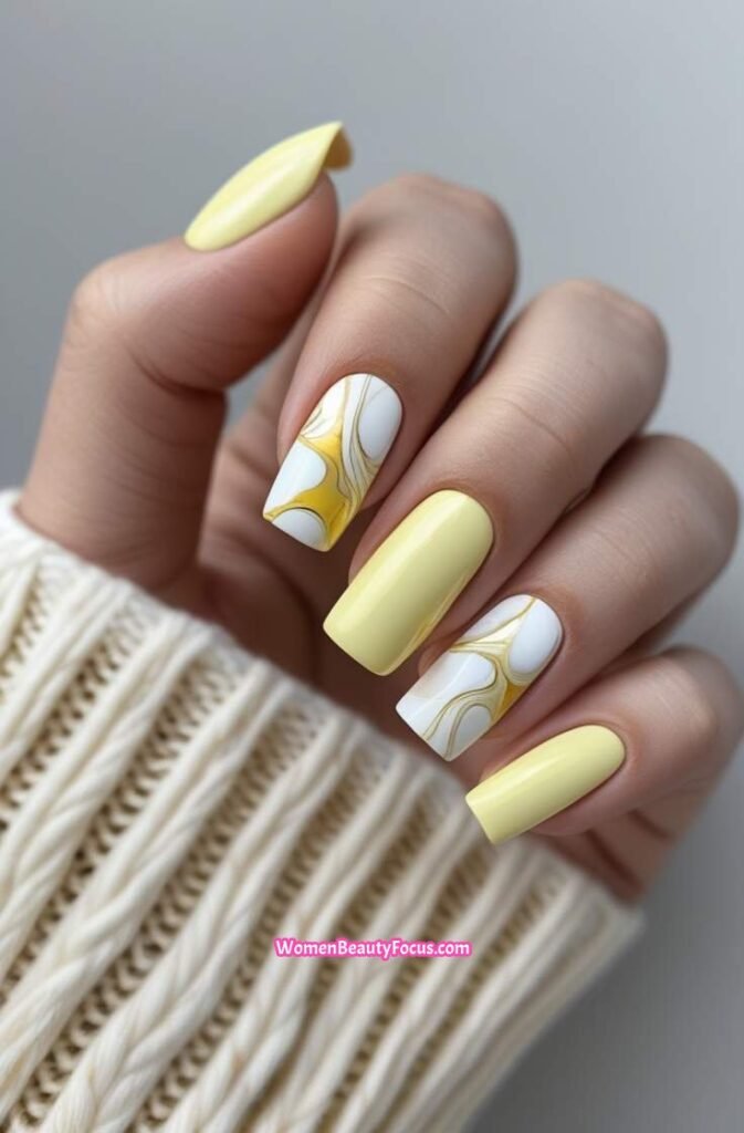 12. Marbled Yellow Accent Nails