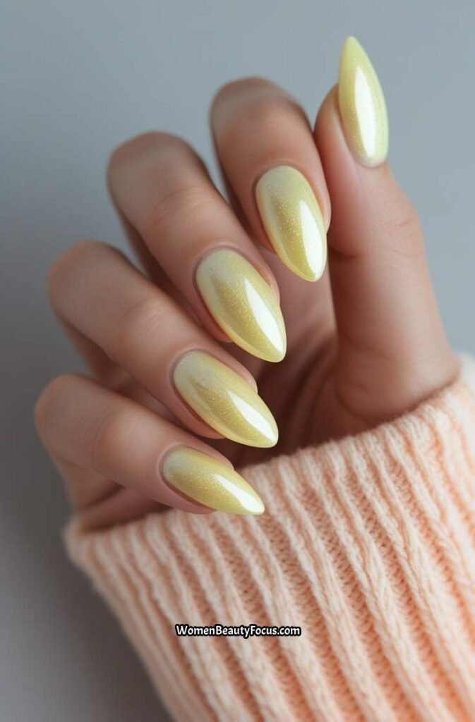 12. Pale Yellow Chrome Almond Nails with Sheen