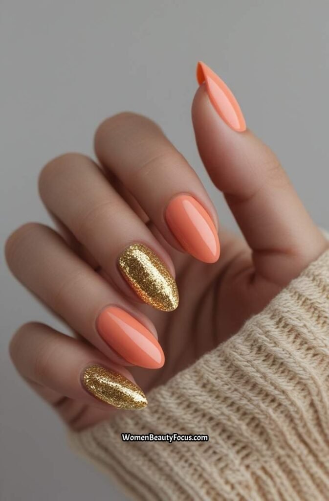 12. Soft Coral Nails with Gold Glitter Fade