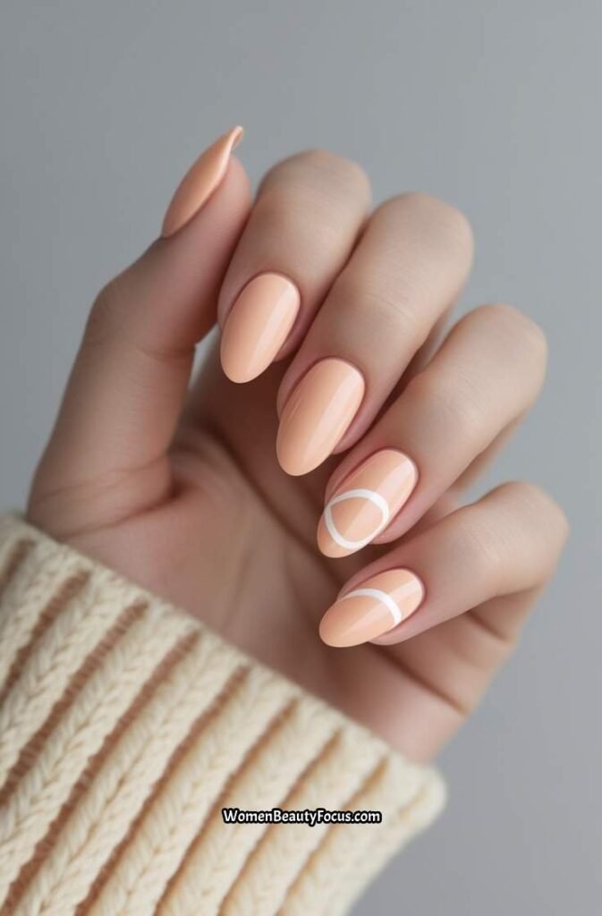 12. Soft Peach Pastel Nails with Minimal Swirls
