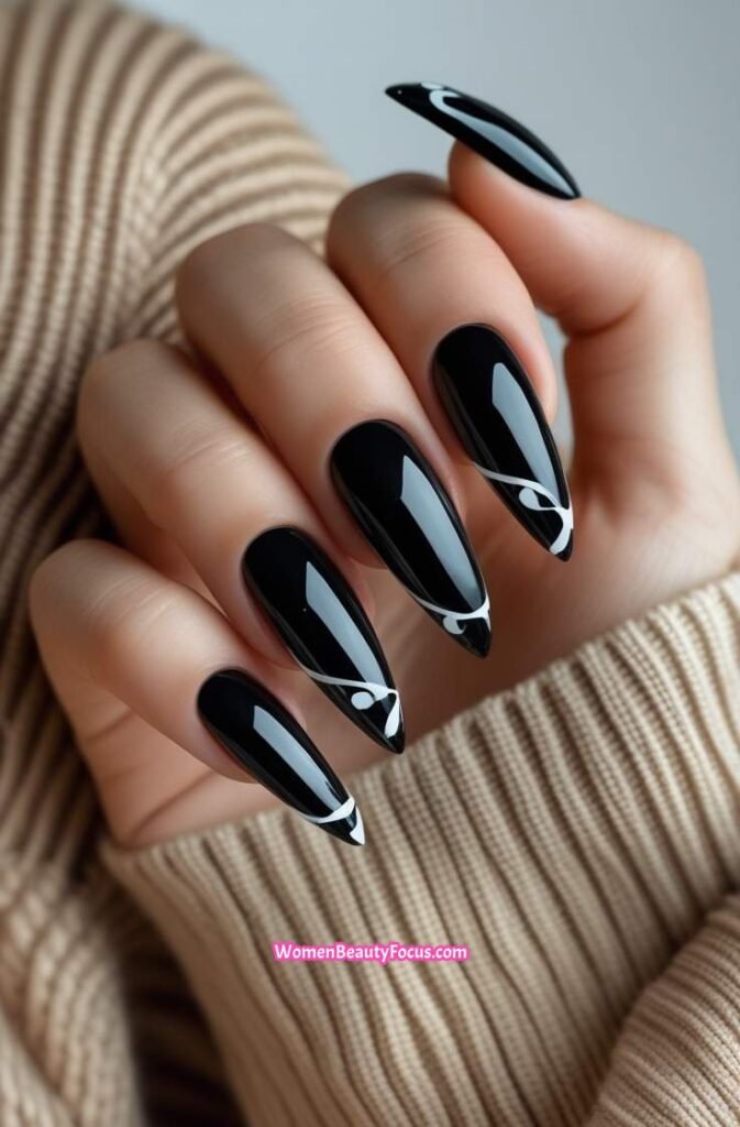 13. Glossy Black Stiletto Nails with White Swirls 13 IMGCentury