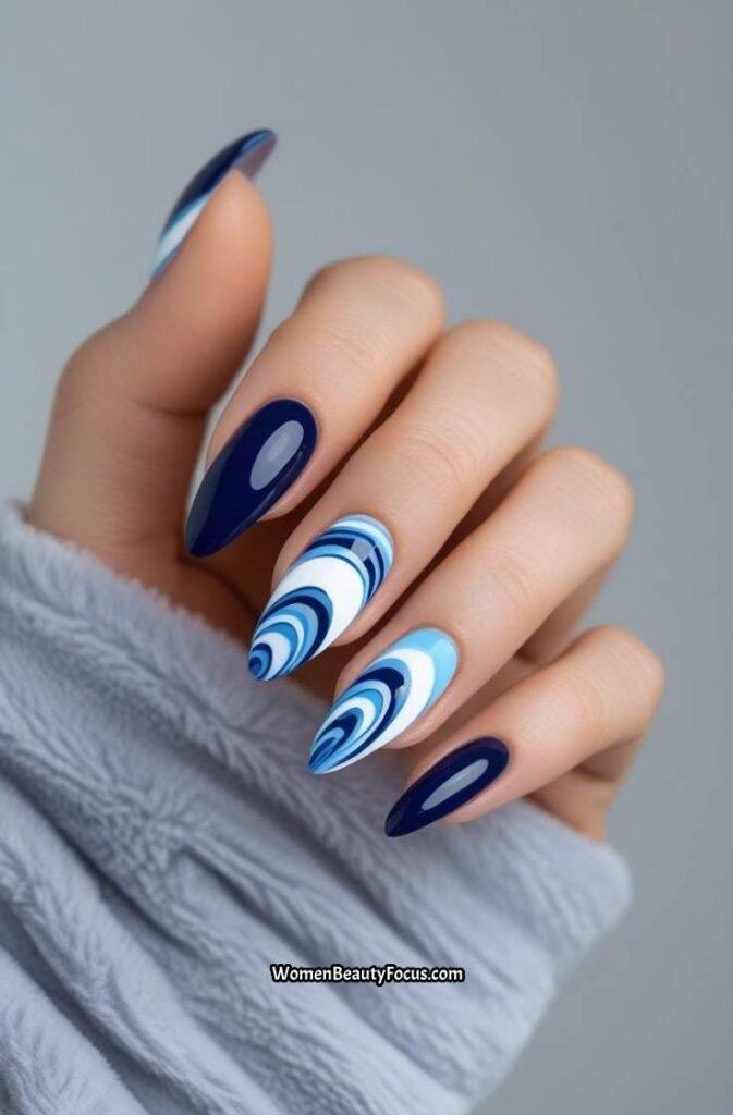 13. Navy and Sky Blue Swirl Nails