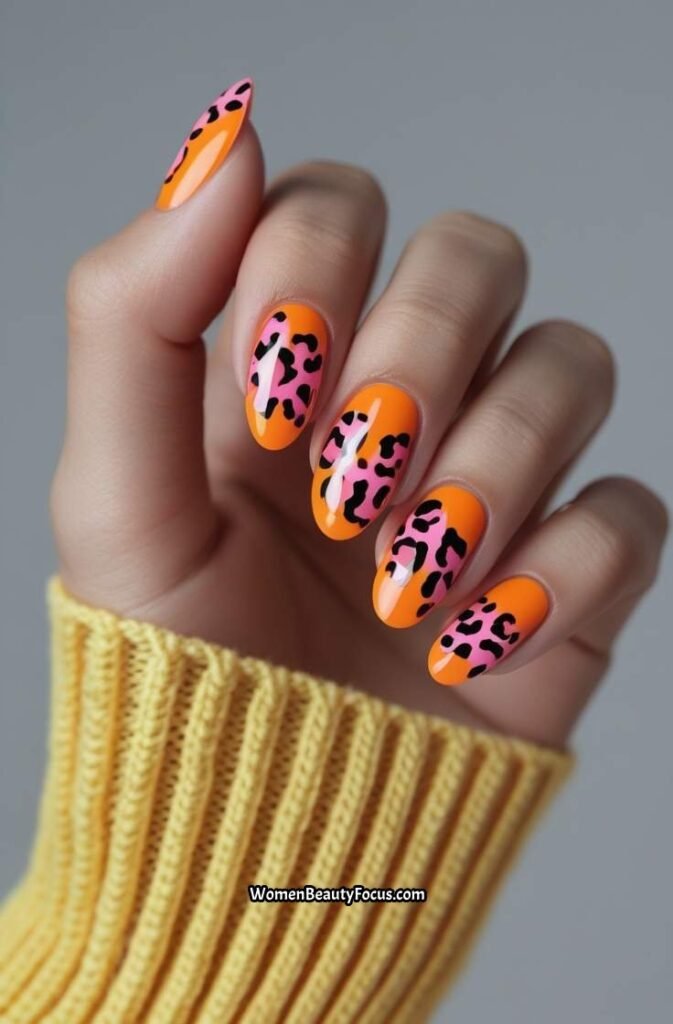 13. Orange and Pink Leopard Print Nails