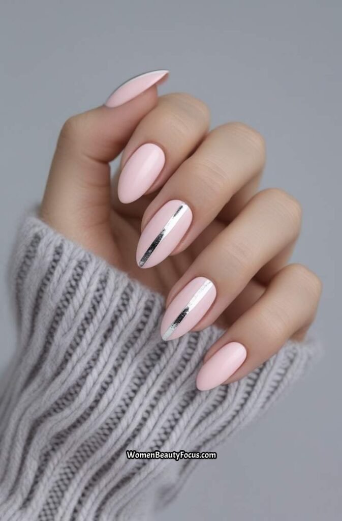 13. Pale Pink Almond Nails with Silver Stripes