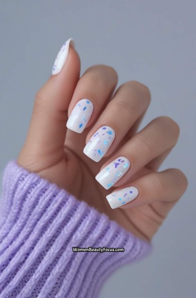 13. White Nails with Iridescent Glitter Flakes