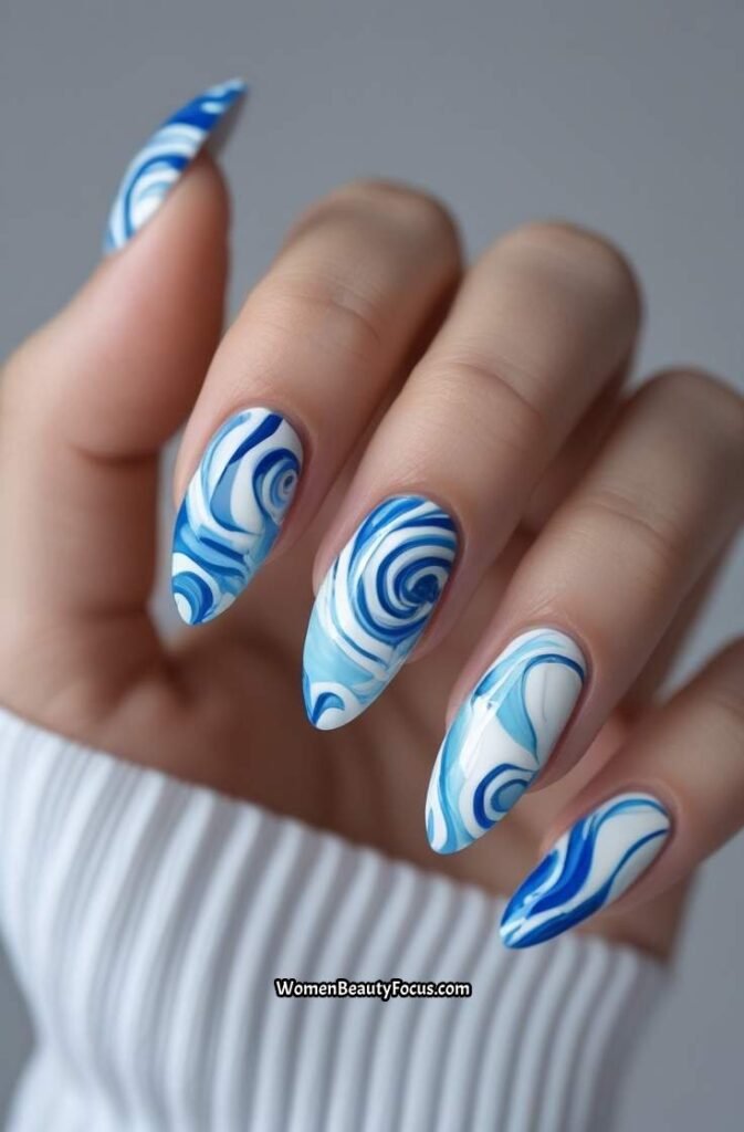 14. Blue Tie Dye Swirl Nails
