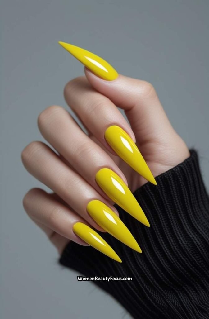 14. Glossy Yellow Chrome Stiletto Nails